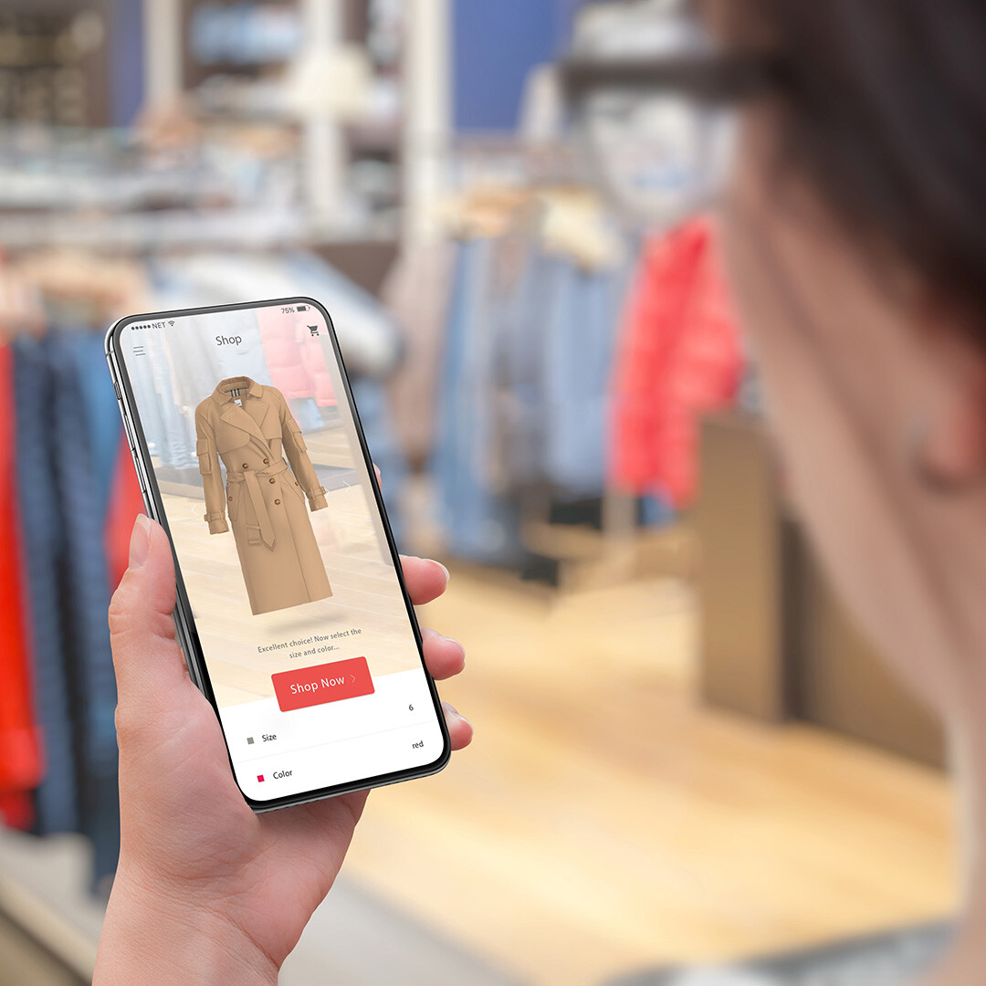 Person Using Smartphone to View Beige Trench Coat in Augmented Reality, AR Shopping Experience